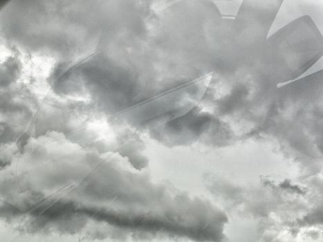 Black cloud before rainy. Black cloud background. Shot from car mirror. Process with more grain. With copy space for text or design.