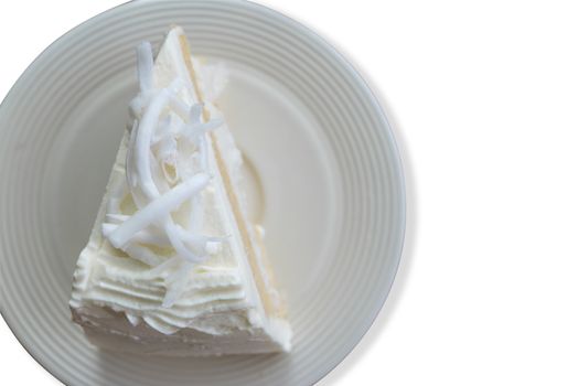 Top view close up coconut cream cake with slice Coconut on top isolate on white background. Save with cliping path.