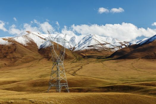 High voltage power line in Kyrgyzstan. electricity pylon in the mountains.