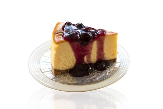 Homemade blueberry cheesecake on white plate. Isolate on white bakcground