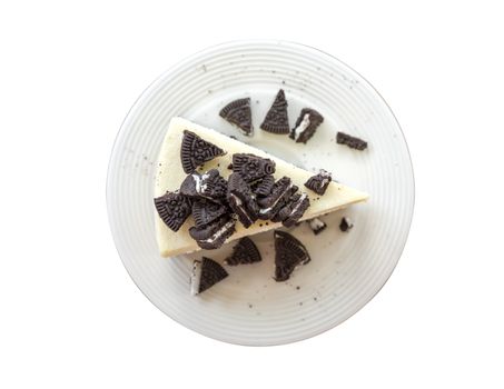 Top view home made cheesecake no brake with chocolate Cookies and Cream on plate. Isolate on white bakcground