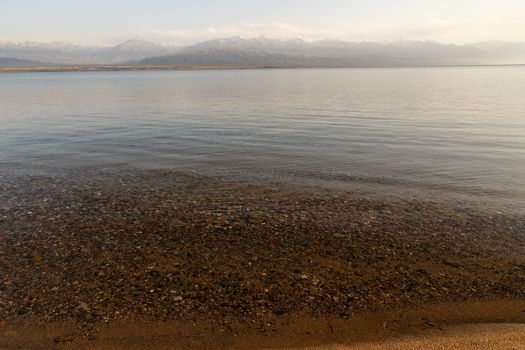 Transparent water on Issyk-Kul Lake in Kyrgyzstan, stones at the bottom of the lake.