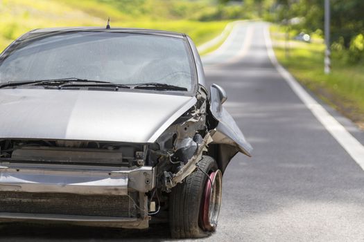 Front of gray color car big damaged and broken by accident on road parking can not drive any more. With copy space for text or design