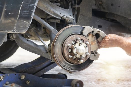 Transportation concept. Hand mechanic repair brake disc . 