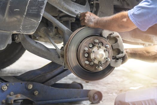 Transportation concept. Hand mechanic repair brake disc . 