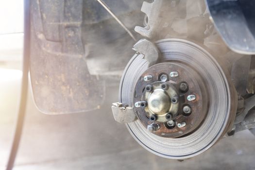 Mechanic use air gun clean disc break take dust removes before change break pat.