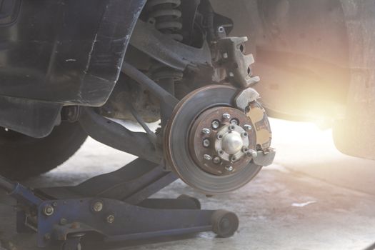 Mechanic use air gun clean disc break take dust removes before change break pat.