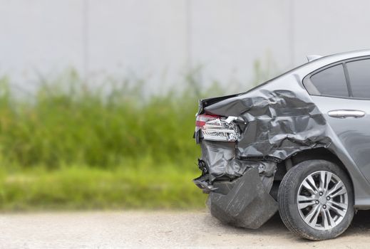 Back side of  gray color car damaged and broken by accident on road parking can not dirve any more. 