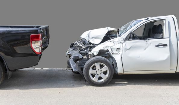 Front White color pack up car crash with back side black color car get damaged by accident on road. Save with clipping path.