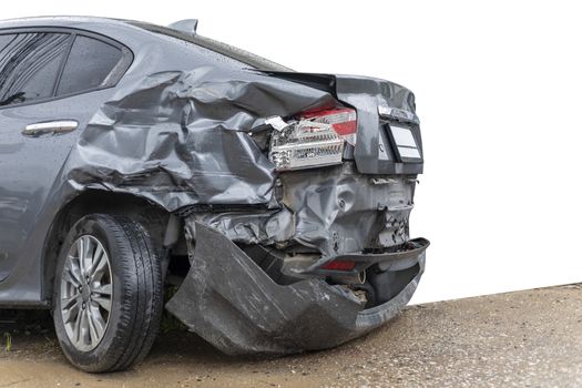 In raining day back side of  gray color car damaged and broken by accident on road parking can not dirve any more. isolate on white background. Save with cliping path