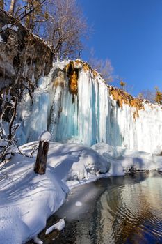 Frozen waterfall and water reflection at plitvice lakes, Croatia