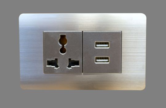 Electric wall plug socket and USB charging port isolate on gray bakcground.