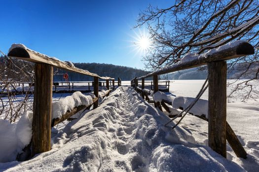 The pier from plitvice lakes during winter covered with snow