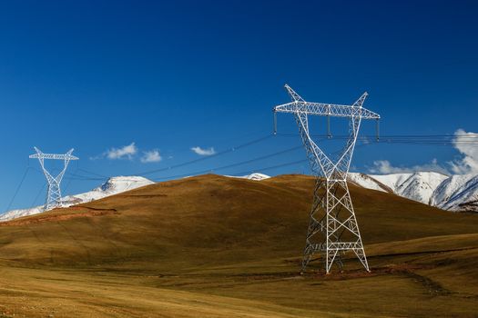 High voltage power line in Kyrgyzstan. electricity pylons in the mountains.