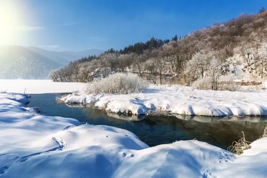 Sun and big snow at plitvice lakes during winter, Croatia, Europe