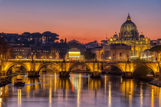 The Tiber river and St. Peters Basilica in the Vatican City, Italy, at sunset