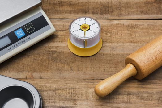Bakery And Cooking Tools with kitchen timer, scales, kitchen mold on wood table