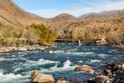 Kokemeren river, Djumgal Kyrgyzstan, broken bridge on the river, beautiful landscape