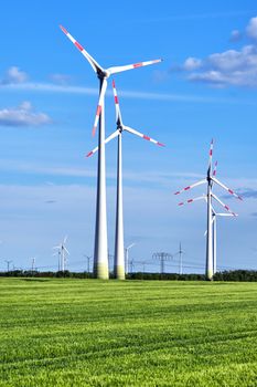 Modern wind wheels in a cornfield seen in Germany