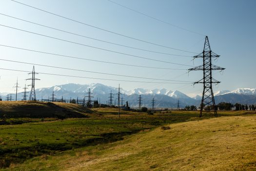 high-voltage power line in the mountains, electric high voltage power post, Kyrgyzstan