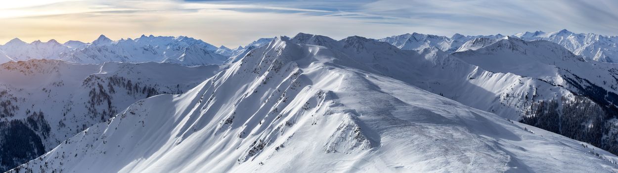 Panoramic view of beautiful winter wonderland mountain scenery in the Alps