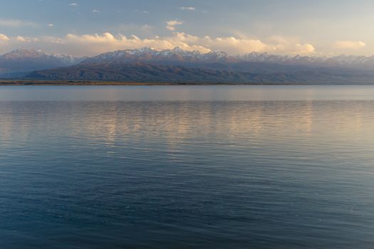 South shore of Issyk-kul lake in Kyrgyzstan, lake on a background of snow-capped mountains