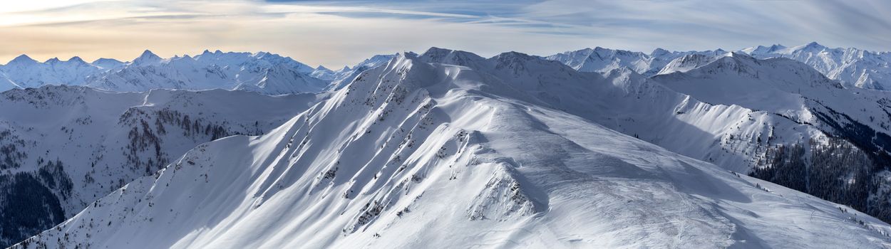 Panoramic view of beautiful winter wonderland mountain scenery in the Alps