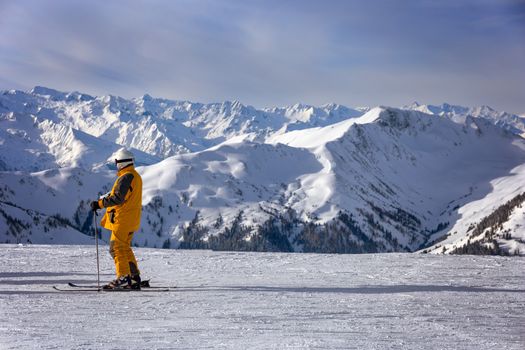 Skier overlooking the piste at Saalbach-Hinterglemm ski resort Austria, Europe