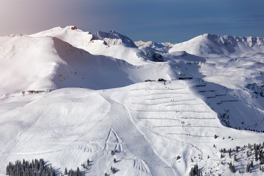 Winter mountains background with ski slopes and ski lifts. Skiing resort. Extreme sport. Active holiday. Free time concept