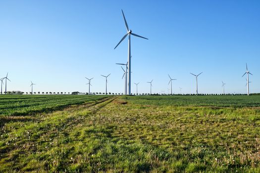 Backlit modern wind turbines seen in Germany
