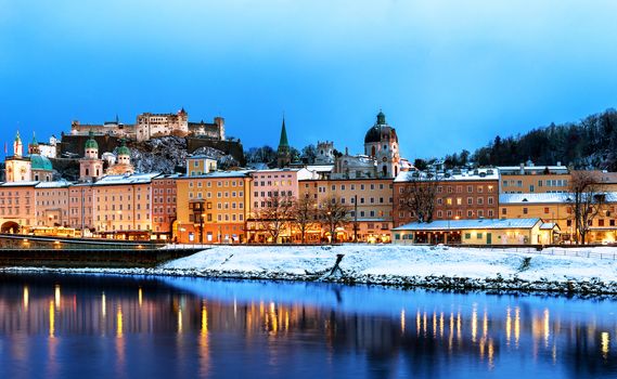 Beautiful view of Salzburg skyline with Festung Hohensalzburg and Salzach river at blue hour, Salzburger Land, Austria