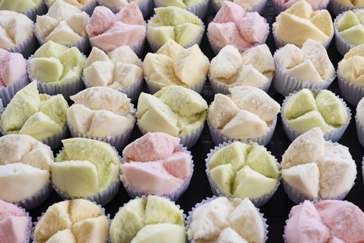 colorfull Thai dessert Thai steamed cupcakes or cakes cotton wool in paper cup on wood table