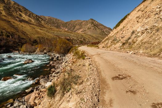 mountain road along the fast river, Kokemeren river, Kyzyl-Oi, Jumgal District, Kyrgyzstan