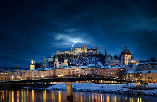 Beautiful view of Salzburg skyline with Festung Hohensalzburg and Salzach river at blue hour, Salzburger Land, Austria