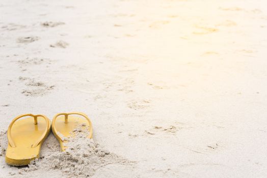 Summer holiday on the beach yellow sandals on the beach have sunset