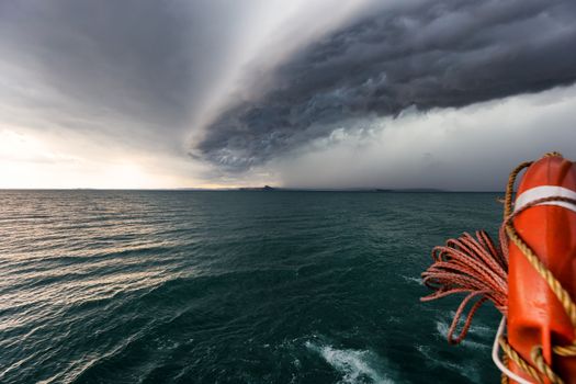 Running from fast coming storm with boat, approaching storm on lake