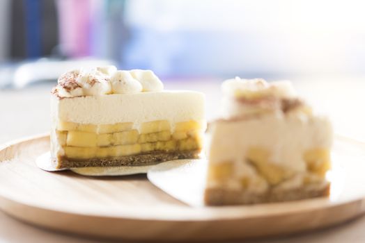 2 Banoffee pie with chocolate powder on wooden plate