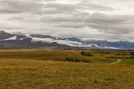 cloudy sky and low clouds in the mountains of Kyrgyzstan, the northern shore of Lake Issyk-Kul