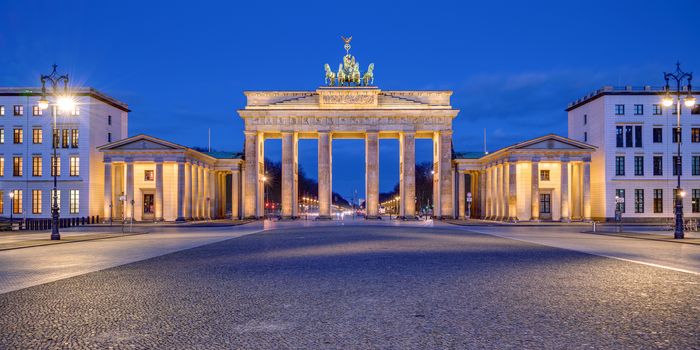 Panorama of the illuminated Brandenburg Gate in Berlin at dawn