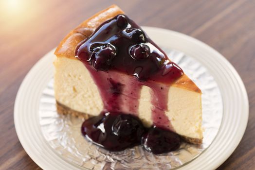 Homemade blueberry New York cheesecake on white plate