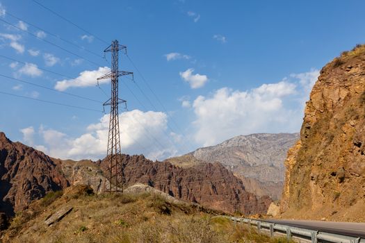 high voltage power transmission pylon in the mountains, high voltage post Mountain landscape, Toktogul, Kyrgyzstan