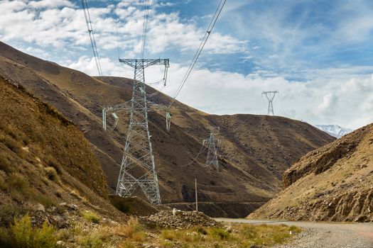 high voltage power transmission pylon in the mountains, high voltage post Mountain landscape, Kyrgyzstan