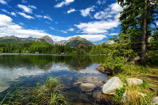 Strbske pleso. High tatras mountains. Vysoke tatry. Autumn forest. Reflection in lake. Beautiful landscape. Slovakia. Hotel Patria