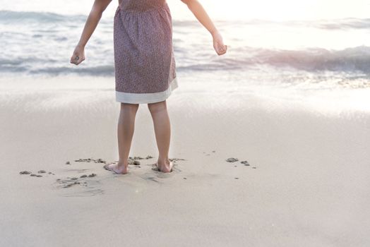 Children stand on the beach