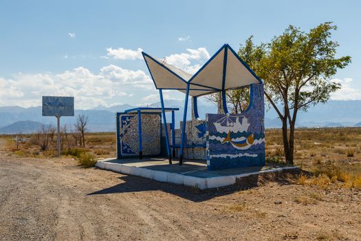 empty bus stop on the road, waiting place for the bus, Issyk-Kul Lake, Kyrgyzstan