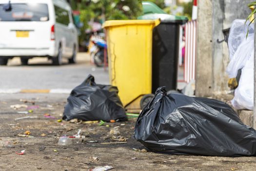 Big and many plastic garbage bag on streets with garbage sitting on ground