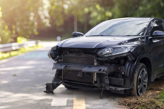 Front of black color car big damaged and broken by accident on city street parking can not drive any more. With copy space for text or design