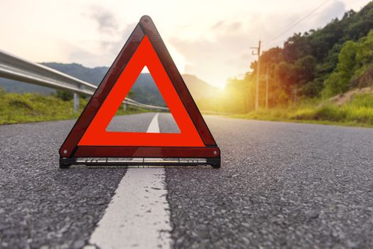 Red triangle, red emergency stop sign, red emergency symbol on road. 