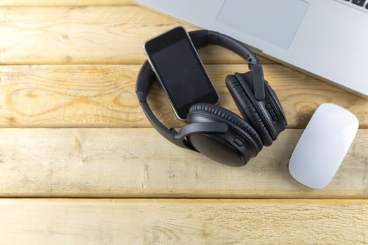 Headphone, Keybord, Mouse and music portable on wood table with copy space for text or design.