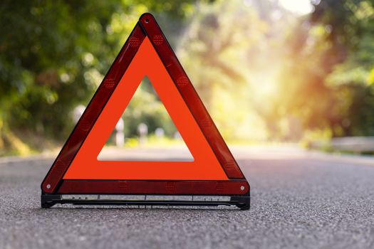 Red triangle, red emergency stop sign, red emergency symbol on road.